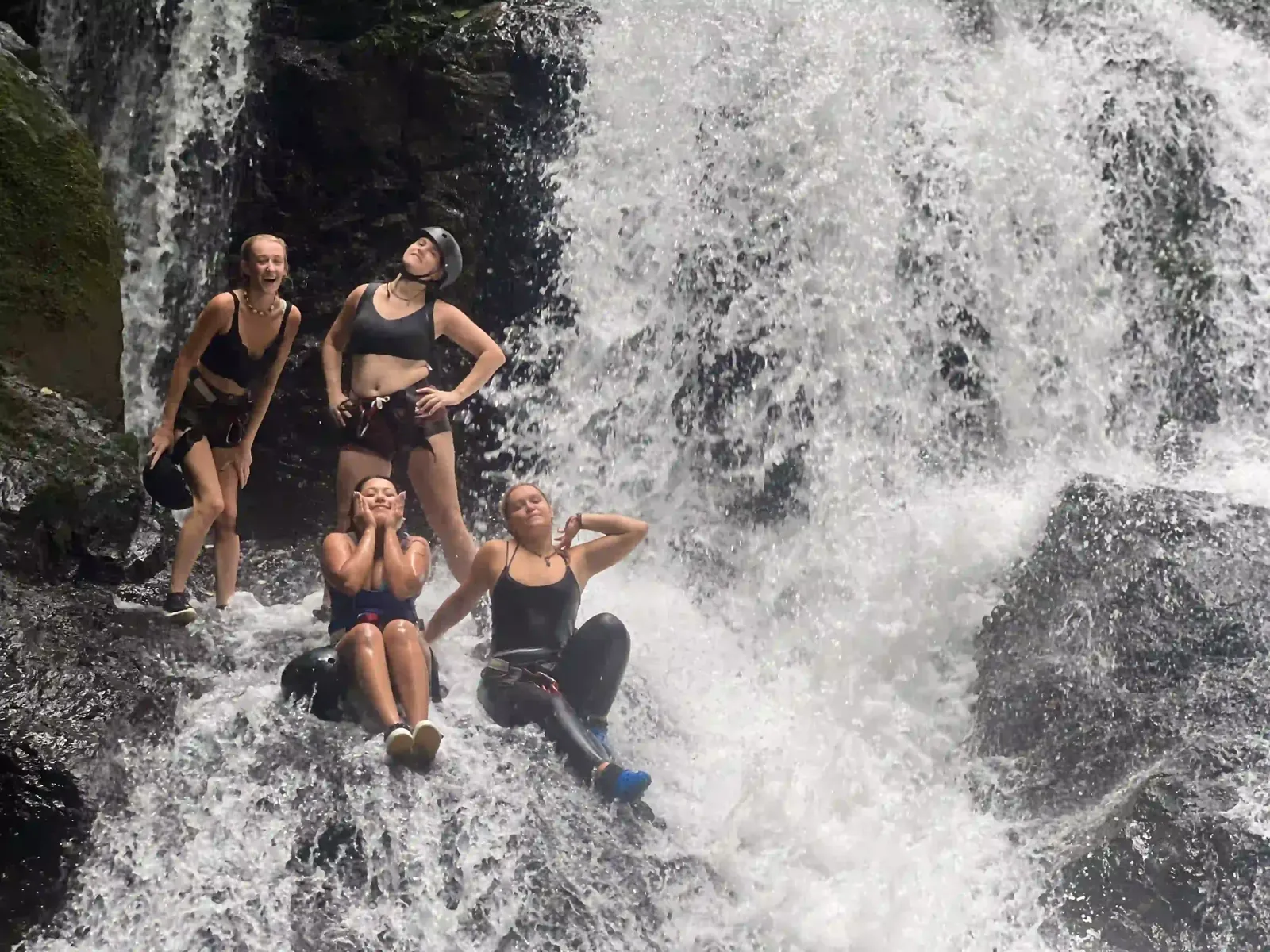 Young traveler rappelling a rainforest waterfall on a guided family adventure in the Osa Peninsula, Costa Rica